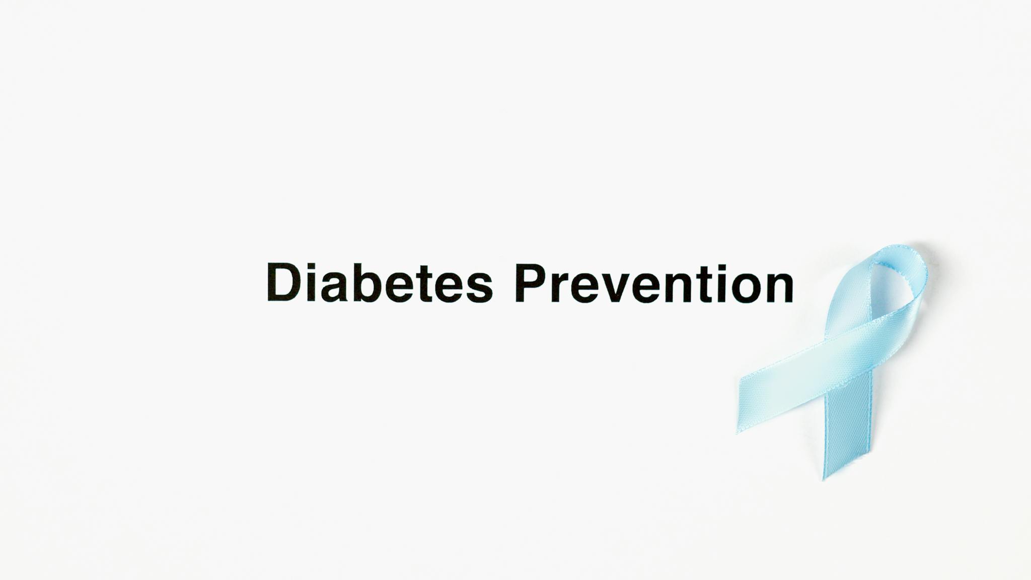 Image of a blue ribbon symbolizing diabetes prevention on a white background.